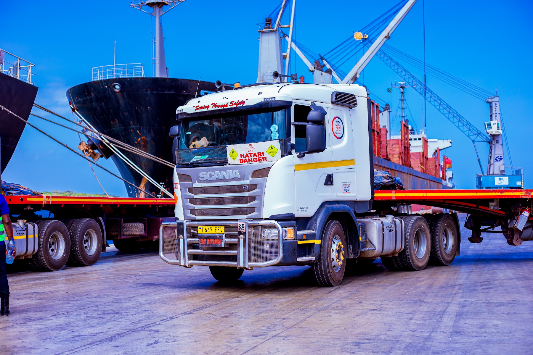 SAS Logistics heavy-duty truck operating beside a cargo vessel